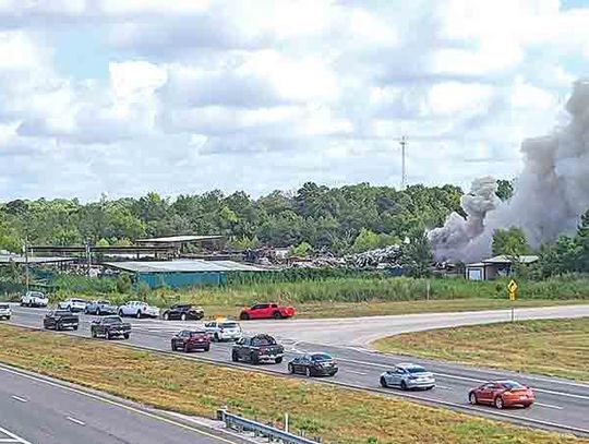 Holding the line - More than a dozen fire departments fight Highway 59 flames for hours