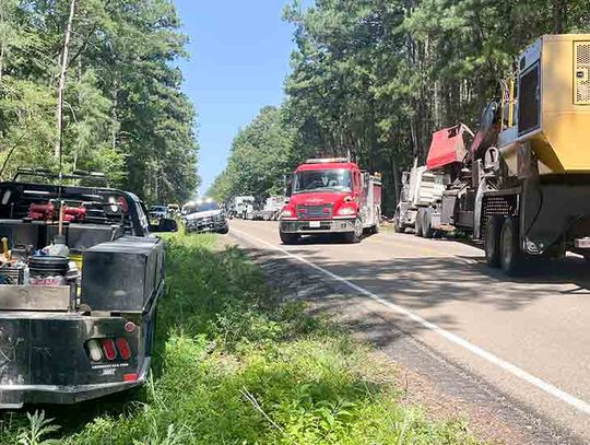 Logging truck overturns