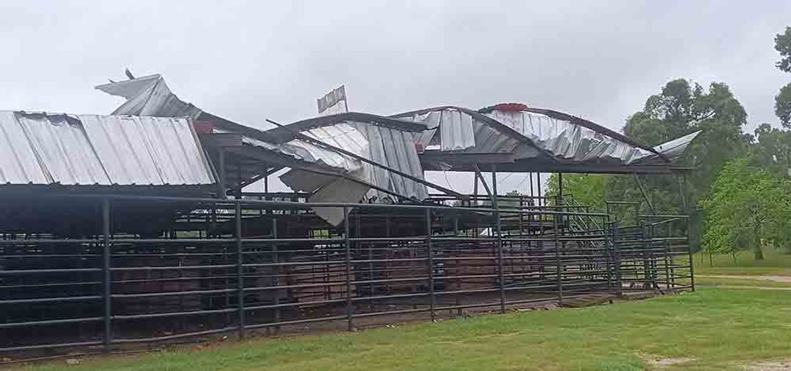 Winds from Beryl peeled back the roof of some of the livestock pens at Barney Wiggins Memorial Arena