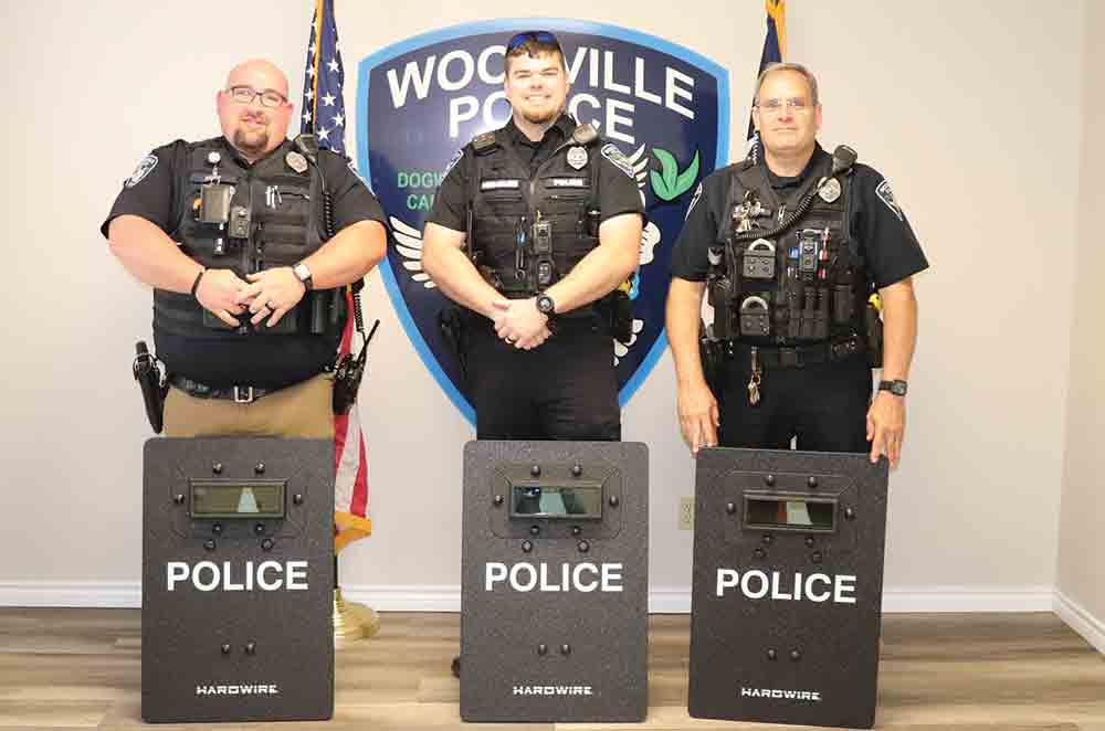 Woodville Police Department officers Steven Hoke, Grant Hensarling and Mike Williams, pictured left-to-right pose with their new Hardwire Tactical Shields, acquired through grant funding.  CHRIS EDWARDS | TCB