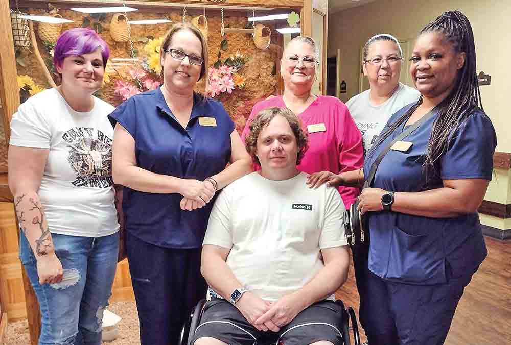 Staff and resident Bobby at Woodland Park nursing home in Shepherd.  Courtesy photo