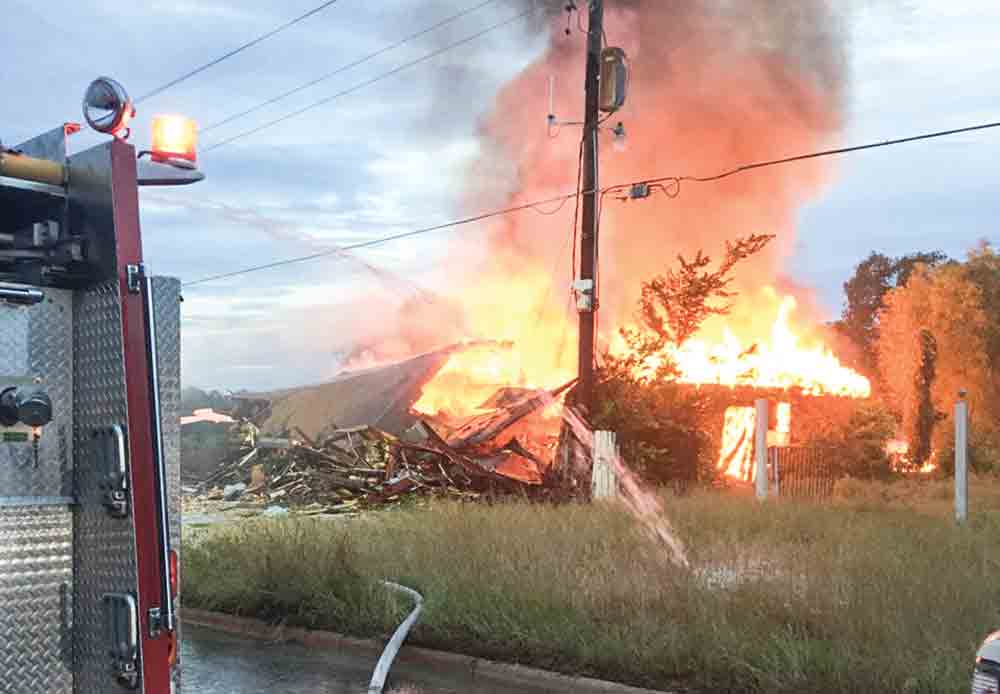 Firefighters battle a blaze in an abandoned building in Trinity that broke out Monday afternoon. COURTESY PHOTO