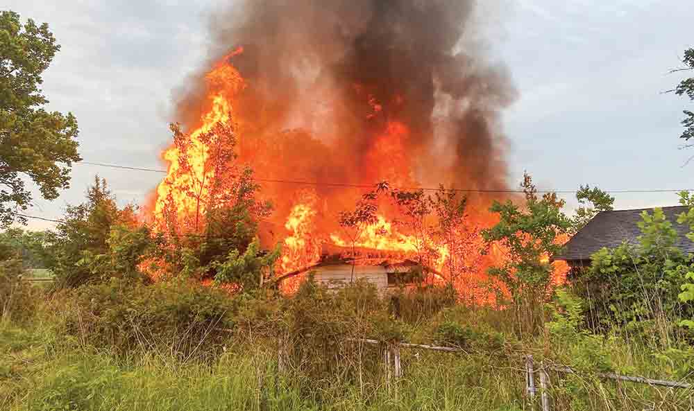 Firefighters battle a blaze that erupted in an abandoned house. COURTESY PHOTO