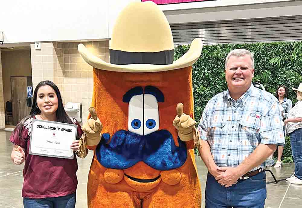 Corrigan-Camden High School Graduate Irissa Vera and Polk County Go Texan Chairman Bill S. Wiggins attend the Houston Livestock Show and Rodeo Scholarship Reception in Houston where Vera was presented a $20,000 scholarship. Courtesy photo