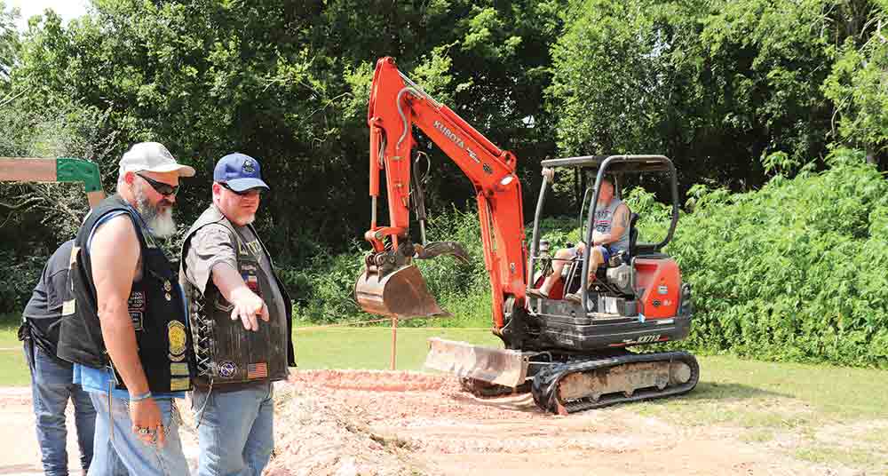 Motorcycle enthusiasts with the Circuit Riders and Radical Disciples get to work building a playground for residents of Castillo’s Children’s Center. CHRIS EDWARDS | TCB