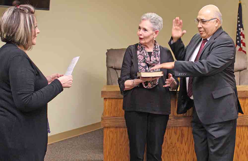 Sergio Ramos is sworn-in by city secretary Terri Bible to begin serving as the temporary municipal judge for the City of Woodville. Ramos’s wife Susan is also shown, assisting him in his swearing-in. MOLLIE LA SALLE | TCB	