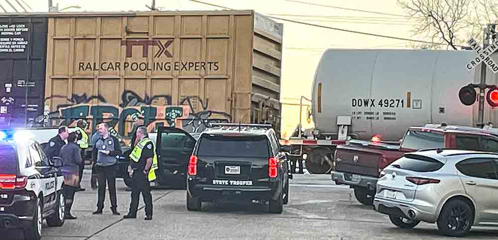 Officers investigate the scene of a train/pedestrian accident that occurred downtown Thursday resulting in the death of a local man.  Photo by Keitha Swann