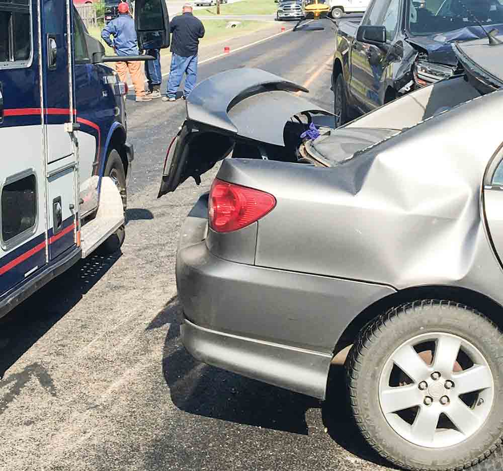 Emergency personnel assist the drivers of two vehicles that collided on FM 356  on Aug. 1. COURTESY PHOTO