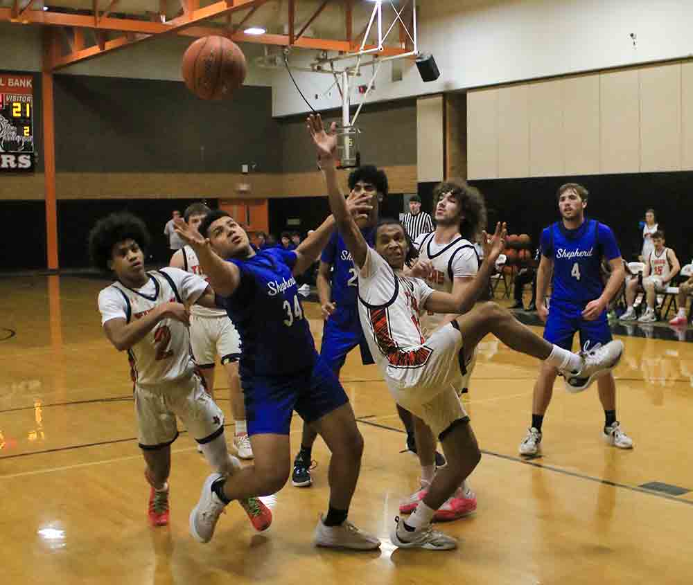 Brayden White (No. 34) and Trinity’s D.C. Cooper move to the right for the loose ball.