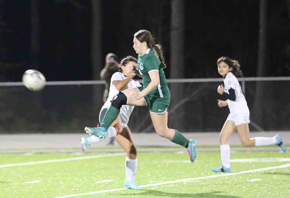 Jayden Vickery, who scored a goal, boots the ball while in the air.