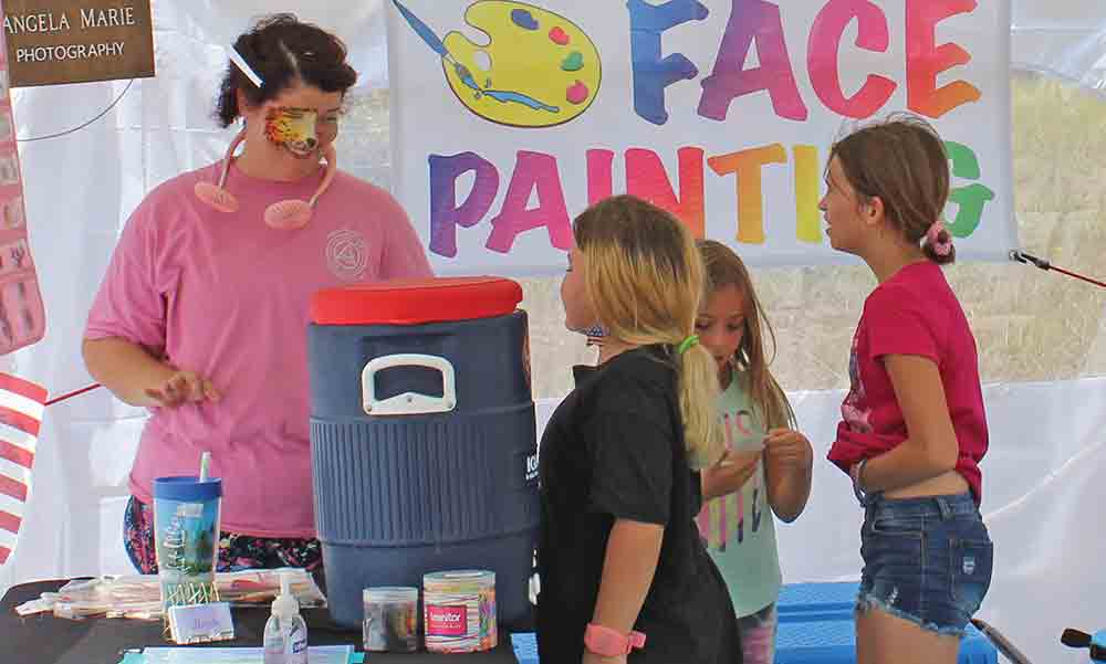 Photographer and face painter Angela Marie was one of the vendors on hand at the inaugural Patriot Day celebration in Woodville last weekend at the VFW Post 2033. MOLLIE LASALLE | TCB