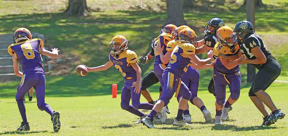 Four JV Yellowjackets hold the line giving Turner Johnson time to handoff to Bryson Swanson for a touchdown.  BECKI BYRD | TCB