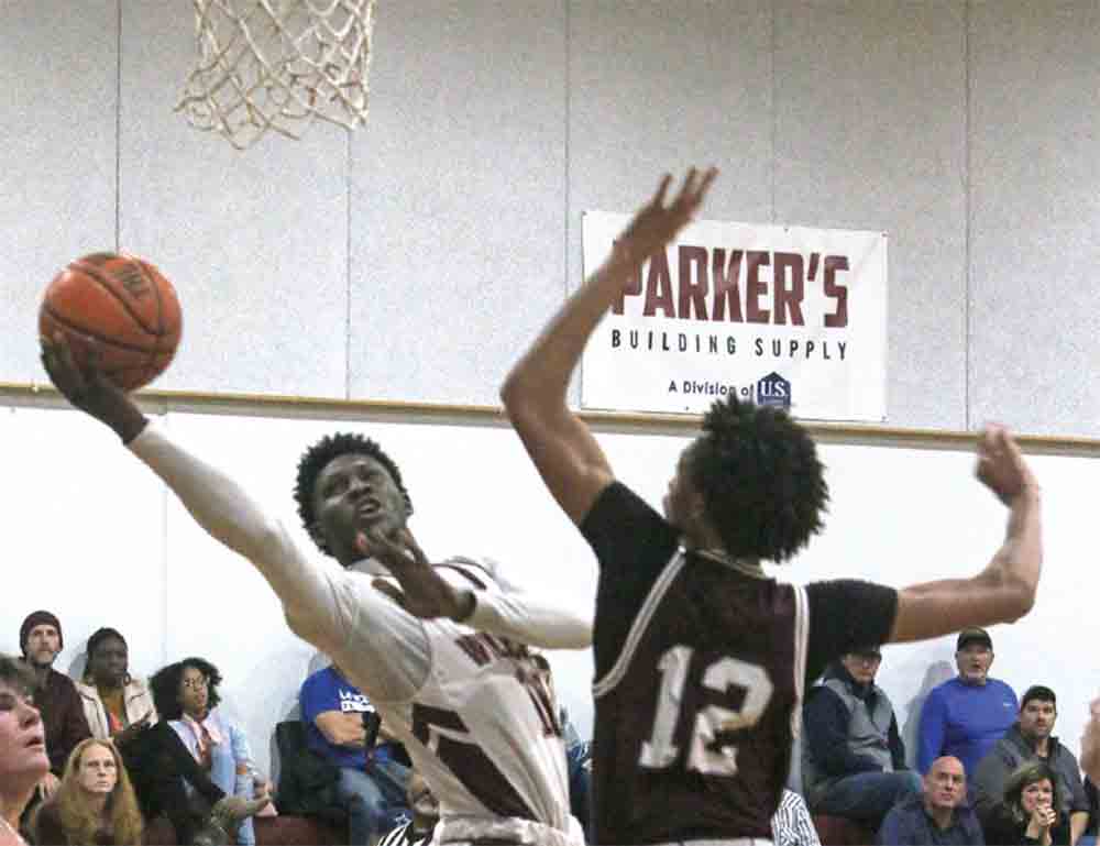 Bryan Wyatt bends around the defense to get a shot up.