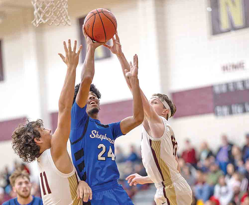 Tristen Cullum pushes his was to the basket against a couple of Longhorns for a district win.