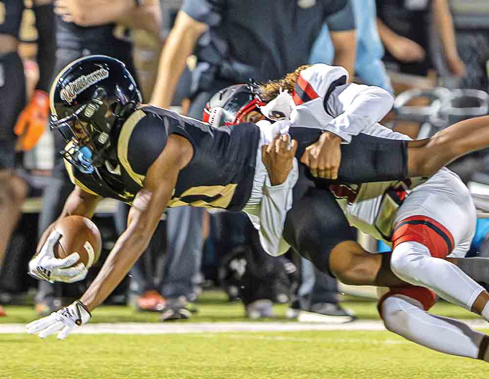 Luke Monroe takes down a loose Eagle as Cody Everett (No. 15) assists. Photo by Charles Ballard