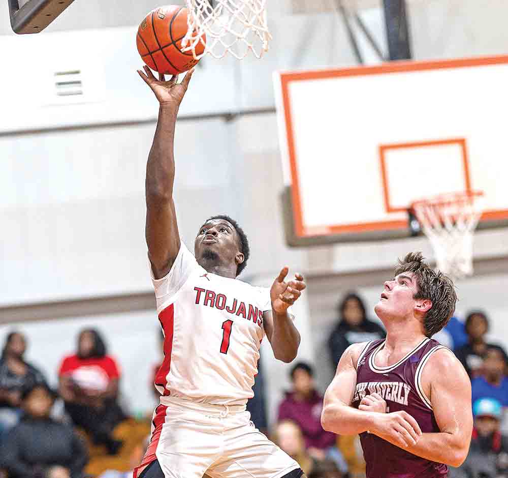 Jacorrion Jackson hits a layup during the district game against the New Waverly Bulldogs. Photos by Charles Ballard