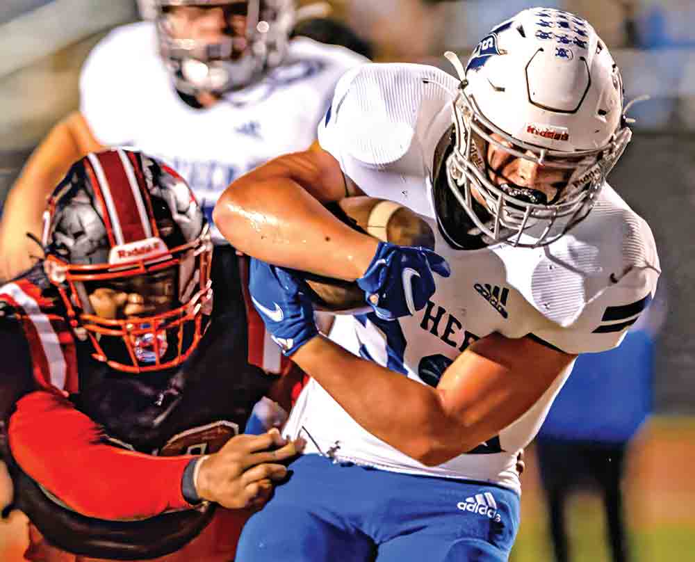 Hunter Kyle evades a near tackle during the district game against the Coldspring Trojans.