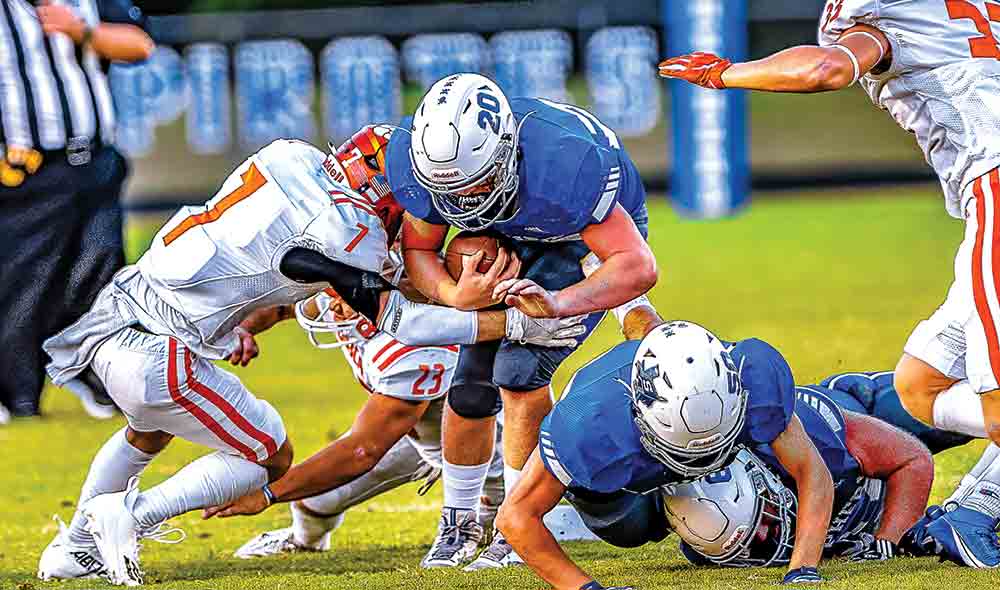 Preston Stephens (No. 20) lunges for every inch he can get against the Bobcats on Friday Night.