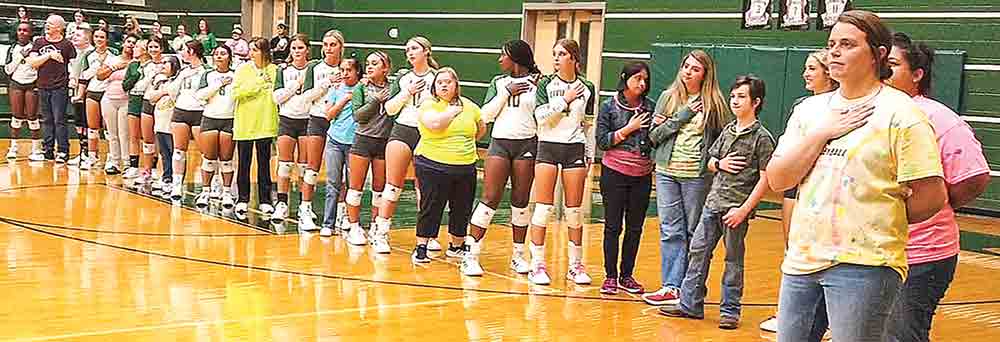 Livingston volleyball stands with their Best Buddies for the national anthem. COURTESY PHOTO