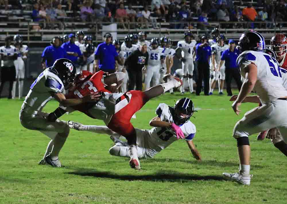 Darius McQueen (No. 13) is tripped up on his way toward a touchdown.