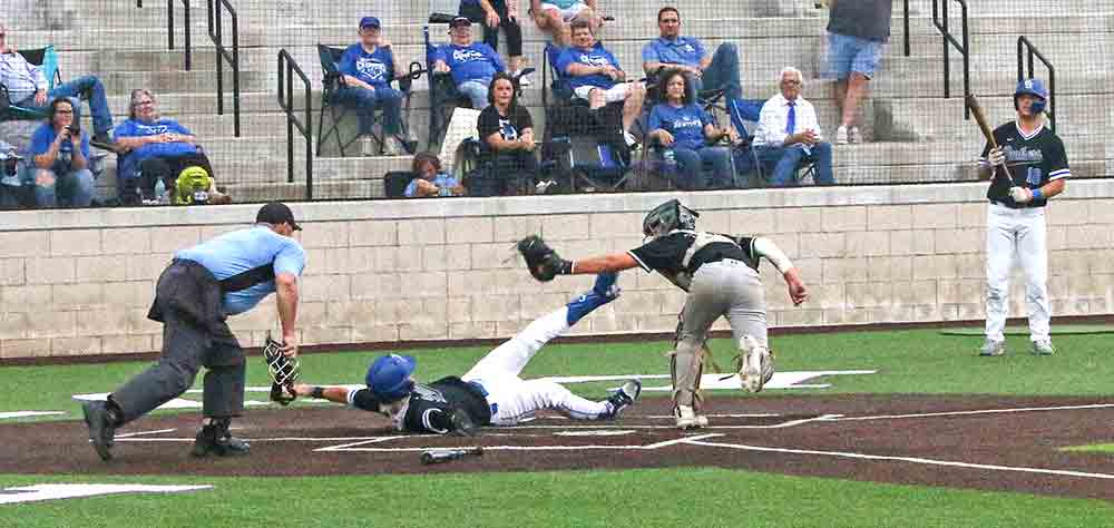 Lion catcher Jordan Huson makes the tag at home plate to keep the game scoreless in the third inning Thursday. PHOTOS BY BRIAN BESCH