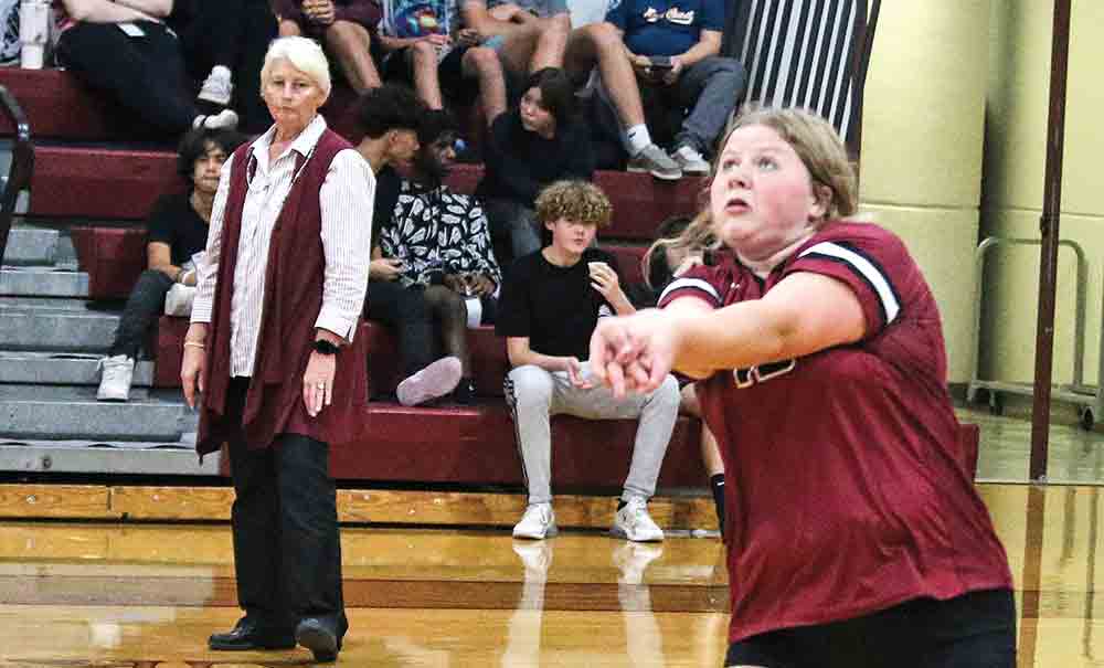  Kalli Saucier gets to the ball as Coach Danna Mitschke looks on.