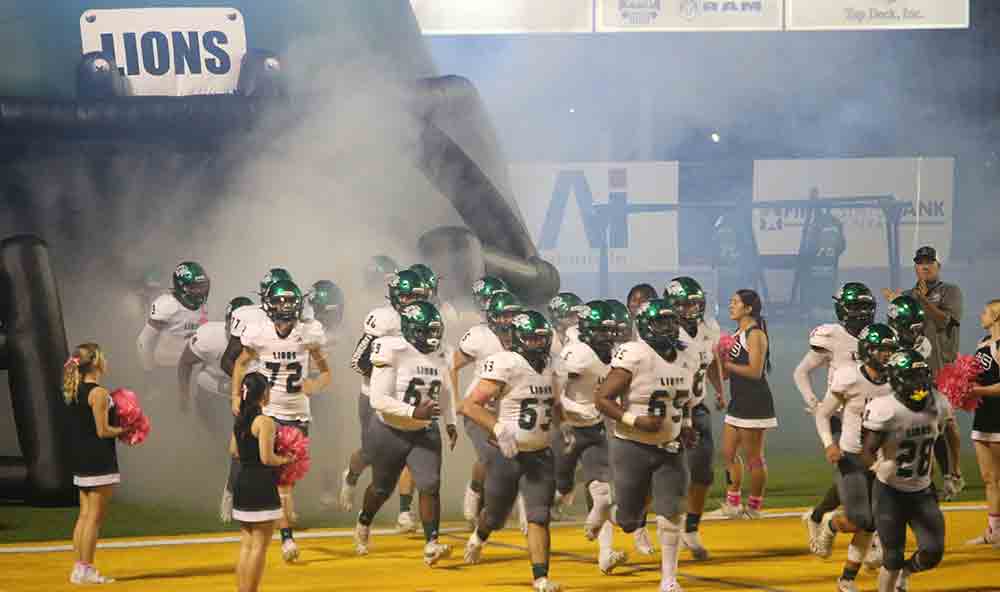 The team runs onto the field for the second half. Photo by Donnie Gokey