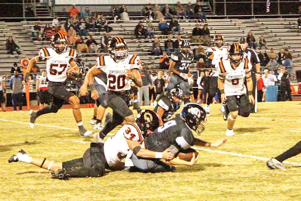 Bulldog junior quarterback Michael Sullivan gets tackled on a short gain.