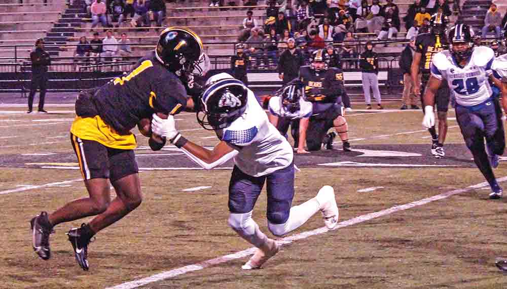 Bulldog senior Tony Cooper makes an open-field tackle on Bear sophomore Dacorian Johnson for a minimal gain. PHOTO BY ALBERT TREVINO