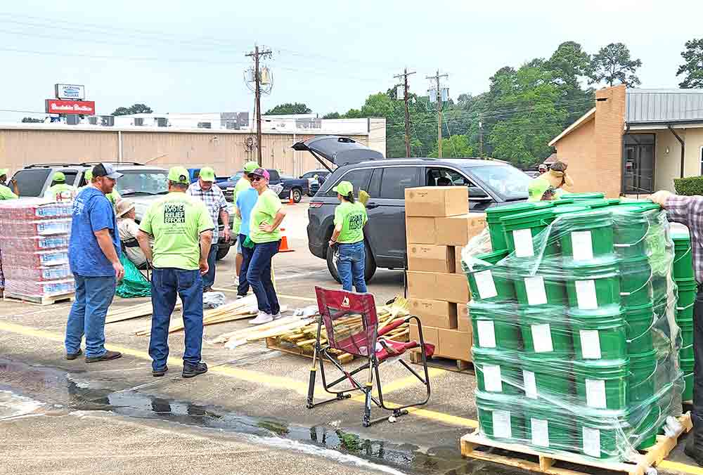 Churches of Christ Disaster Relief Effort Inc. arrived at the Livingston Church of Christ Wednesday, unloaded a 53-foot tractor trailer filled with supplies and formed a staging area where those affected by the floods could just drive through and volunteers could distribute cleanup supplies, boxed ready-to-eat food, paper goods and personal hygiene items. PHOTO BY EMILY BANKS WOOTEN