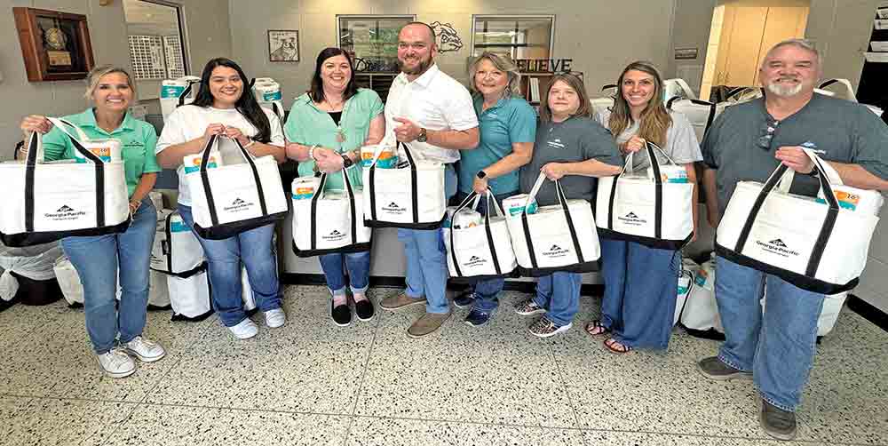 Georgia-Pacific celebrated local educators during National Teacher Appreciation Week, presenting the teachers and staff at Corrigan-Camden High School with canvas tote bags full of Georgia-Pacific tissue and towel products. (l-r) Yana Ogletree, Georgia-Pacific; Aimee Sifuentes, CCISD; Jennifer Wallace, CCISD; Ron Byrd, CCISD; Cathey Page, Georgia-Pacific; Jeannie Handley, Georgia-Pacific; Sage Gardner, CCISD; and John Sutton, Georgia-Pacific. Courtesy photo