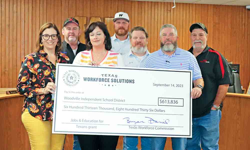 Woodville ISD was presented with a $613,836 grant from Texas Workforce Solutions toward its CTE program. Pictured accepting the check are, left-to-right: WISD Superintendent Lisa Meysembourg; WISD board of trustees member Richard “Kooter” Shaw; Woodville High School Principal Lara Robinson; trustee Kris Fowler; trustee Bryan Shirley; WISD Board President Jimmy Tucker and trustee John David Risinger. CHRIS EDWARDS | TCB